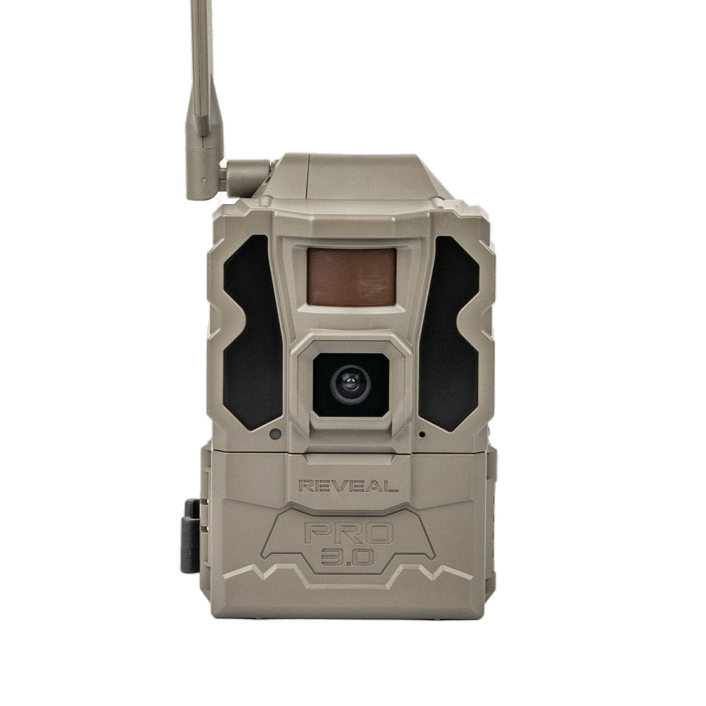 A tactical trail camera in a desert sand color with black accents, featuring an external antenna, a front-facing lens, and the embossed brand name 'REVEAL PRO 3.0' on its front face, set against a plain white background.