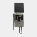 A gray and black electronic device with a rectangular black panel on top, mounted on a stand with a hanging cable, shown against a light gray background.