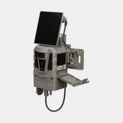 A solar powered trail camera or sensor unit in a gray and black finish, featuring a mounted rectangular screen, side bracket, and attached black cable, shown on a plain light gray background.